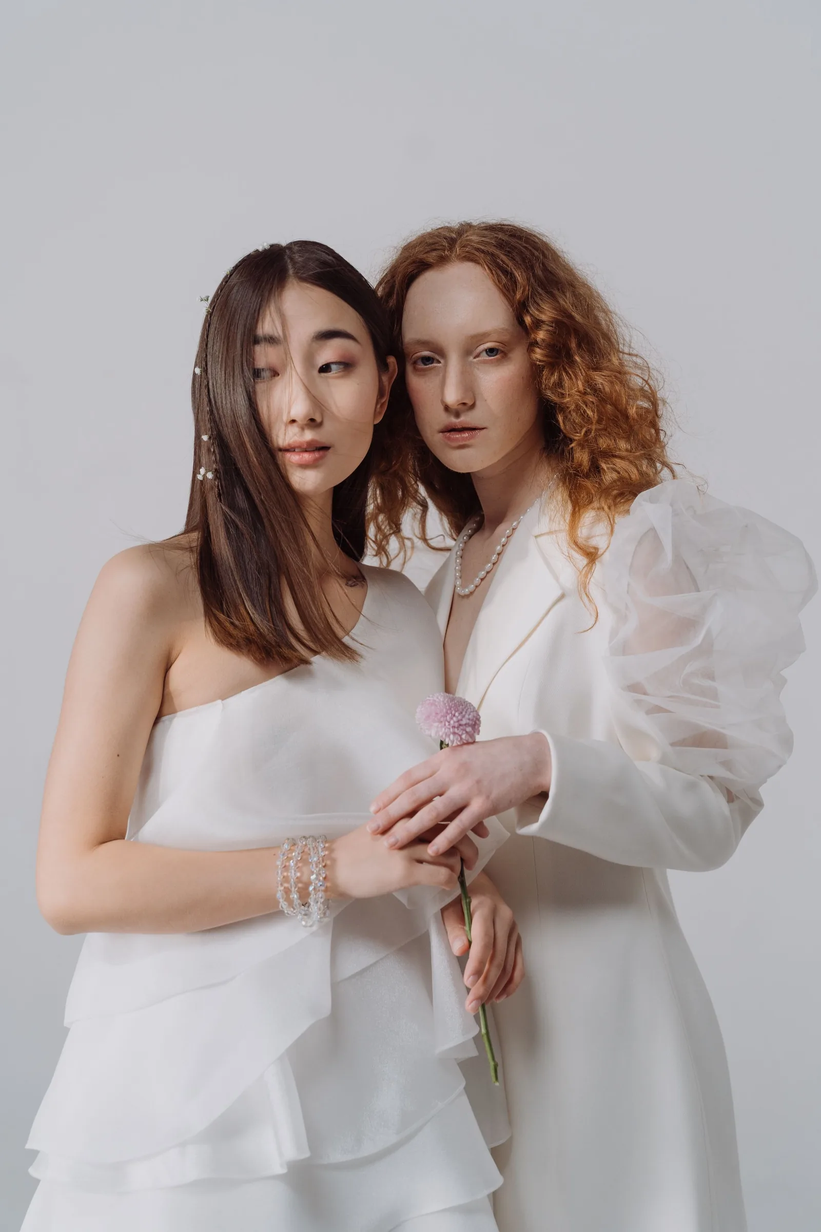 Two women in white dresses in the studio