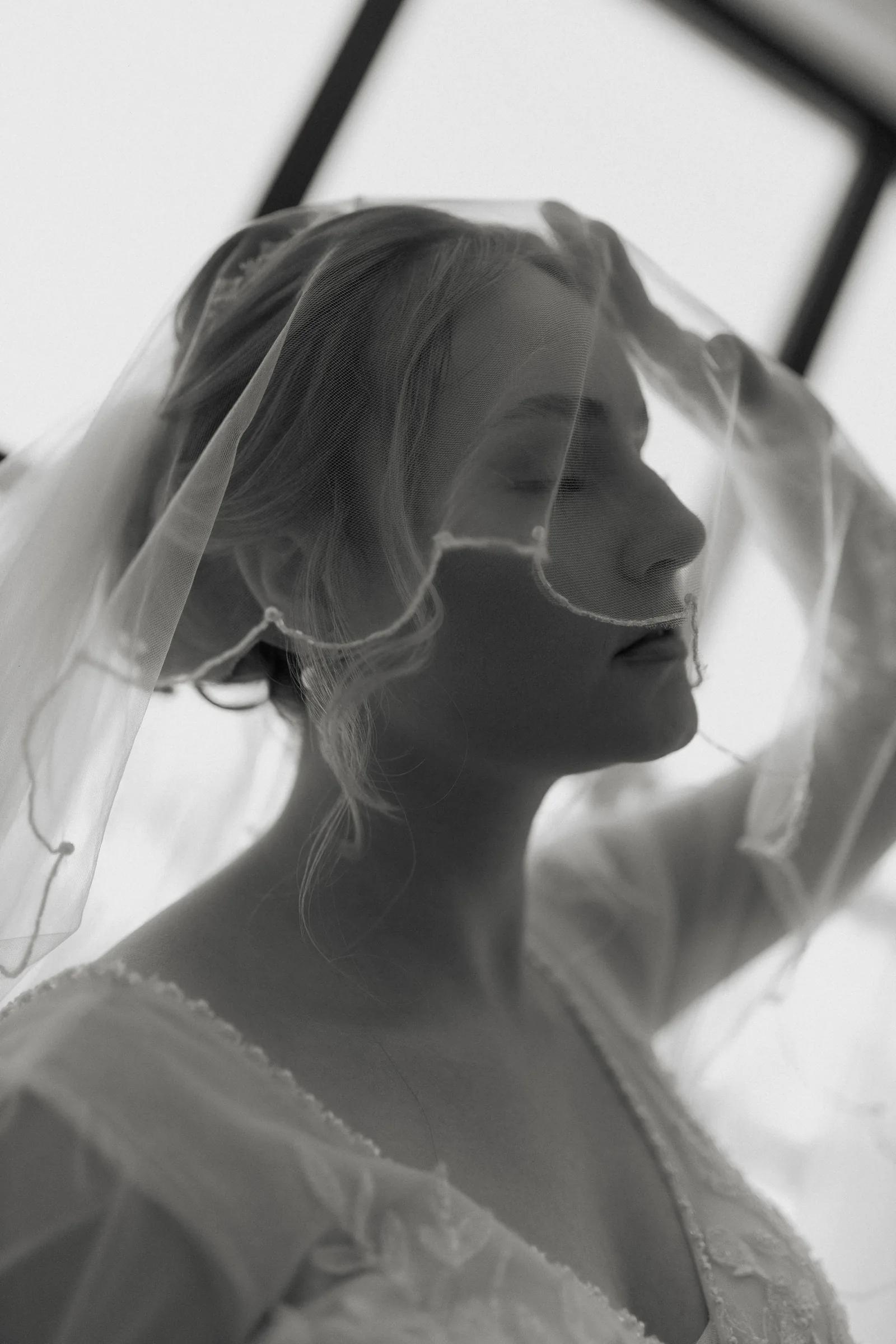 Black and white portrait of a bride under a veil